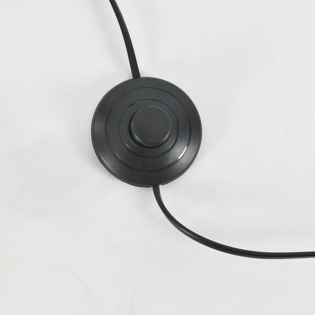 Close-up of the Candied Glass Floor Lamp’s round black foot switch and power cord.