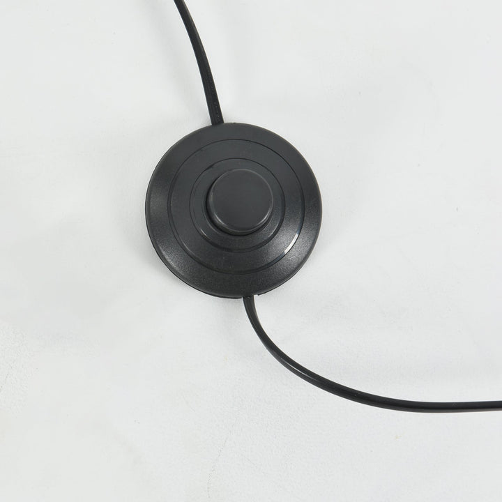 Close-up of the Candied Glass Floor Lamp’s round black foot switch and power cord.