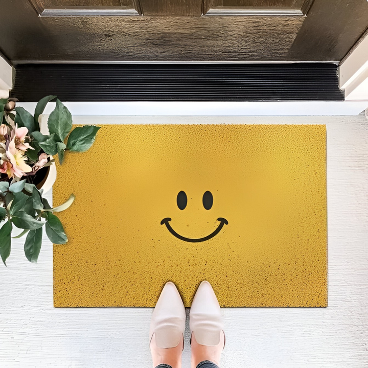 Yellow Cheeky Smiley Print Doormat at front door