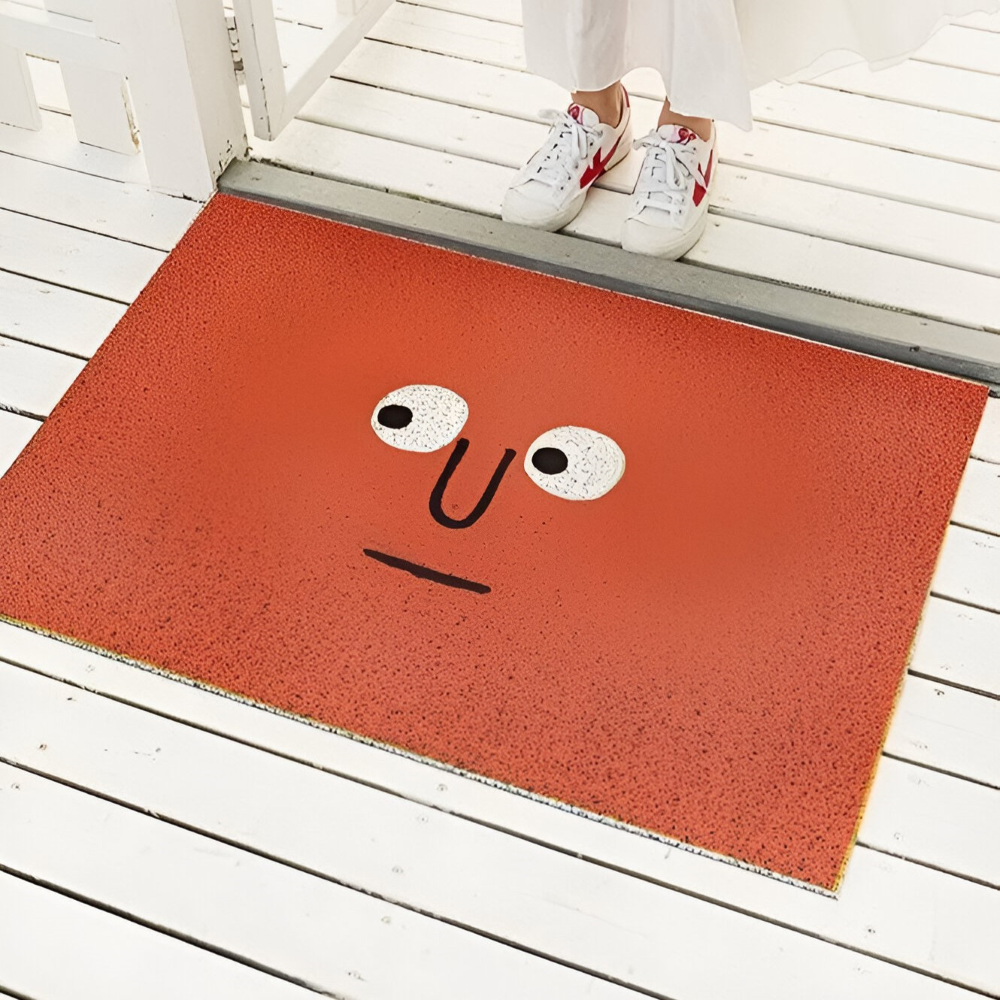 Orange Cheeky Smiley Print Doormat Big Eyes design at doorway