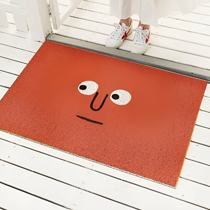 Orange Cheeky Smiley Print Doormat Big Eyes design at doorway