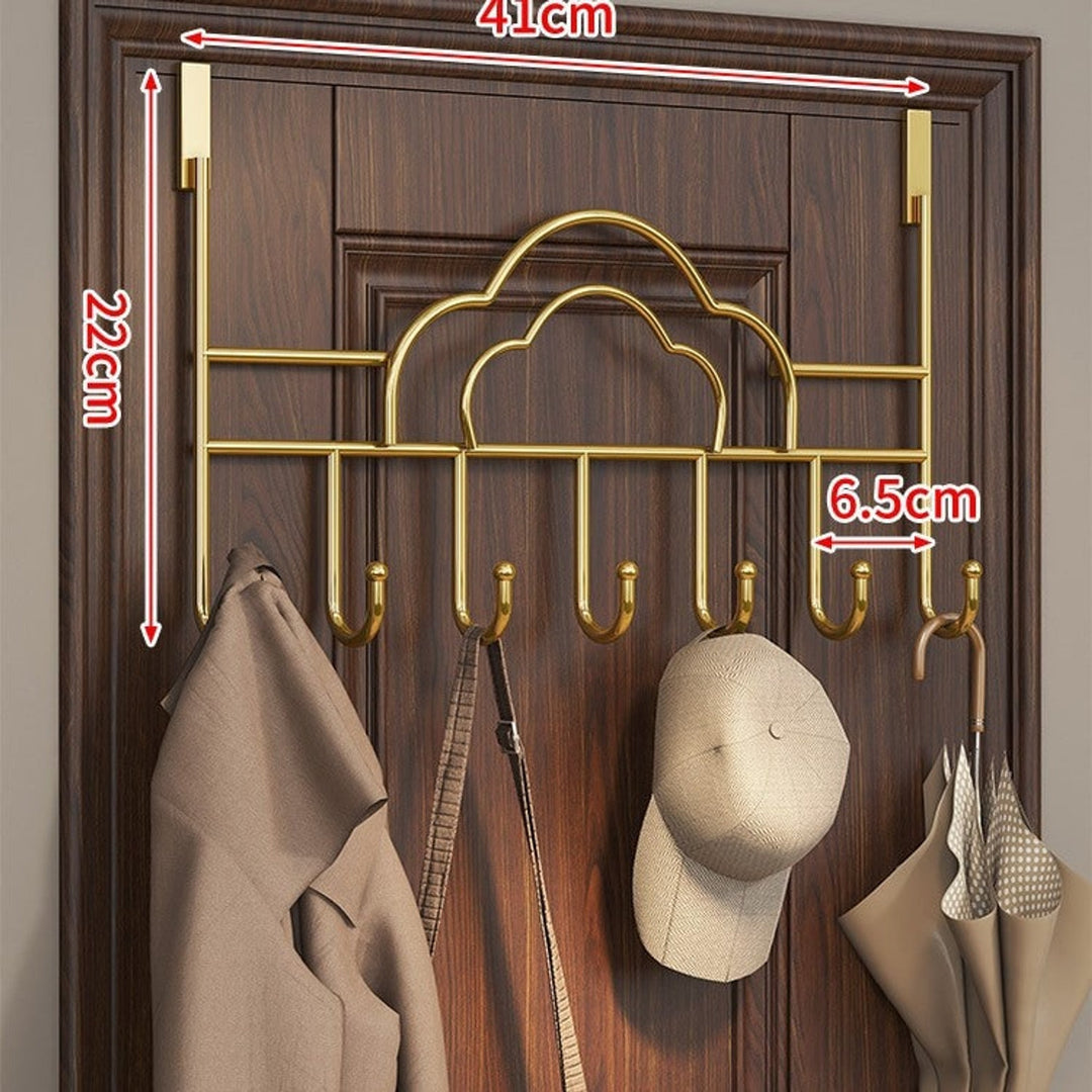 Gold cloud coat rack holding a coat, hat and umbrella