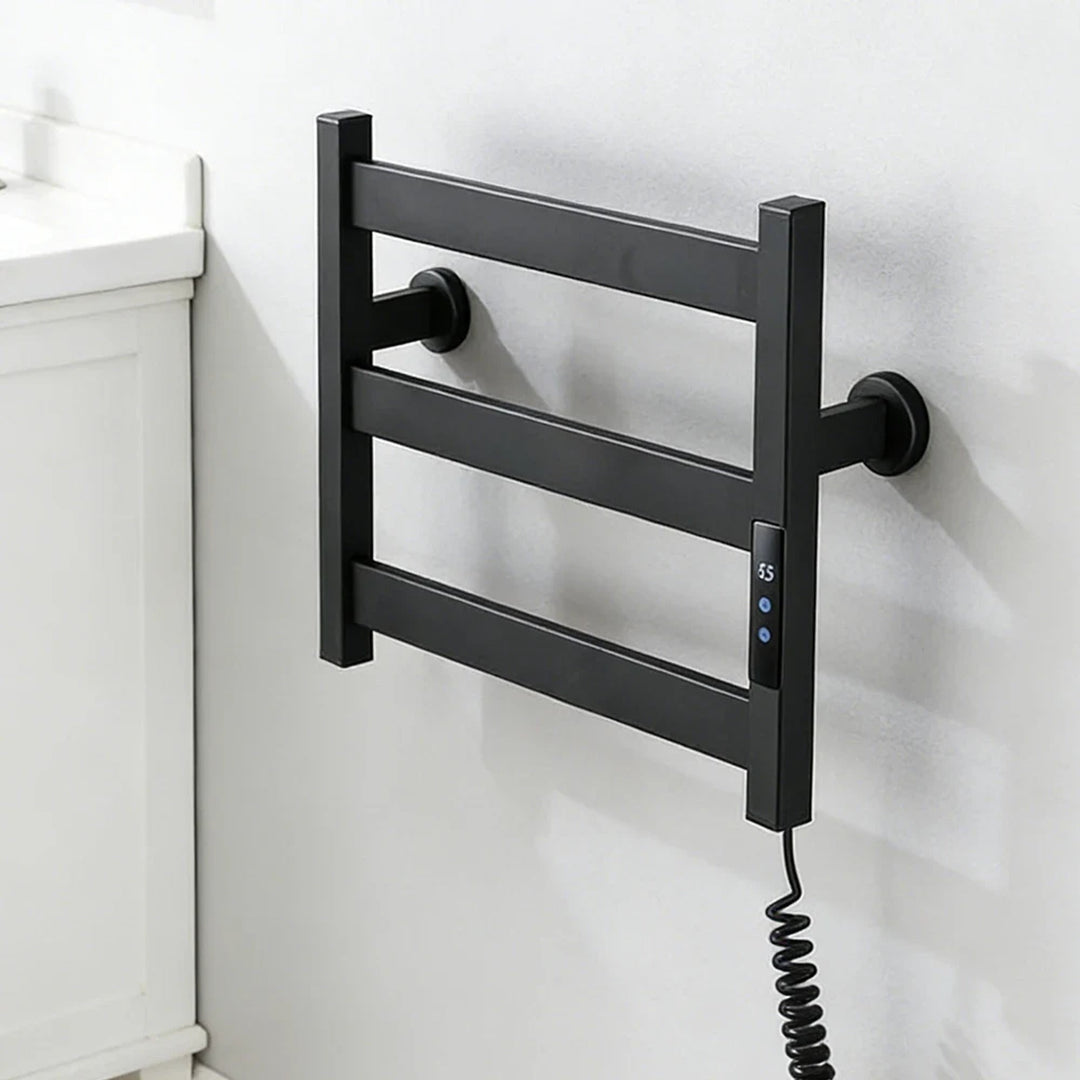 Black three-bar heated towel rack on a white bathroom wall