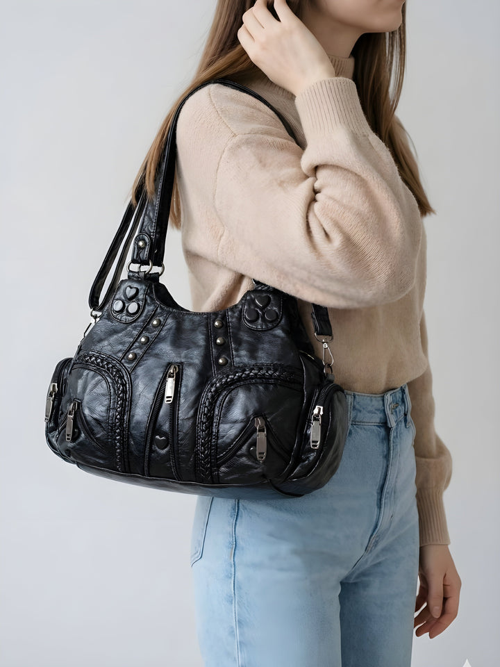 Black Compact Vegan Leather Shoulder Bag worn on shoulder