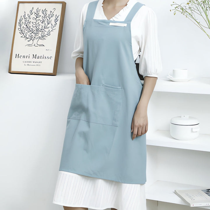Sky Blue Cotton Cross-Back Apron worn in kitchen