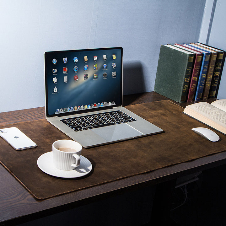 Brown leather desk mat on a home office desk with laptop