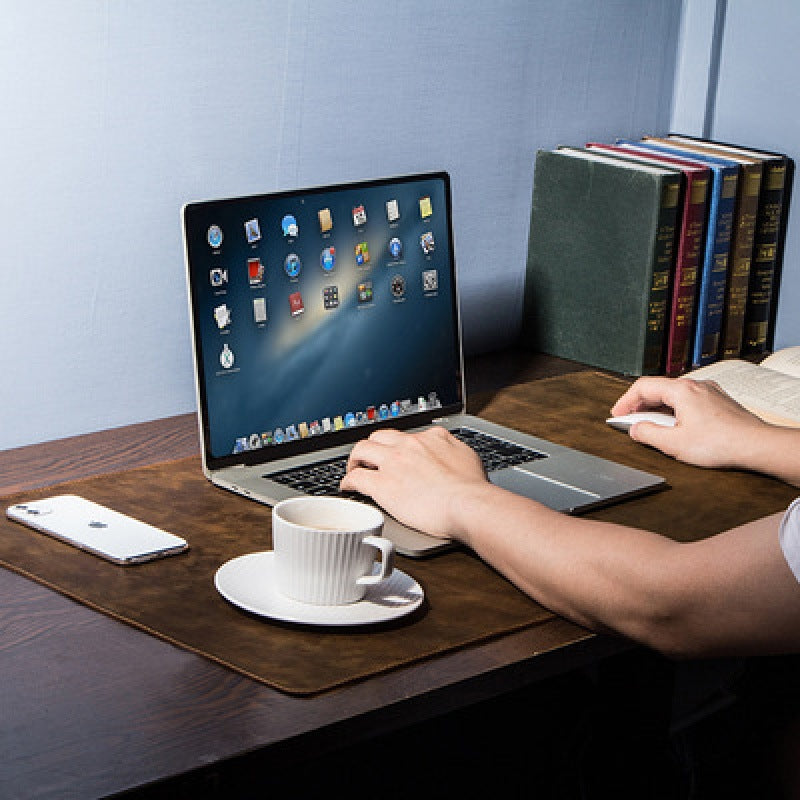 Leather desk mat in use while typing at a desk