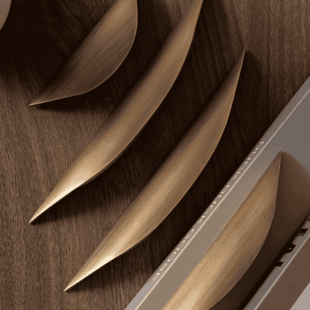 Crescent Brushed Brass Cabinet Pull three sizes on wood surface
