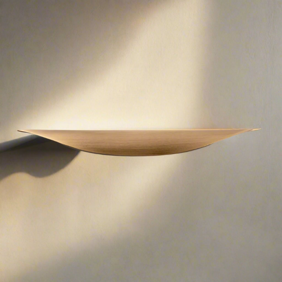 Crescent Brushed Brass Cabinet Pull on drawer front close-up