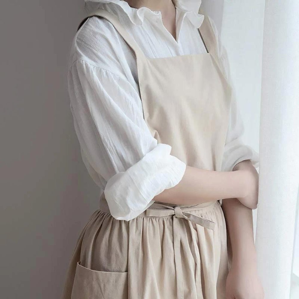 Cross-Back Cotton Kitchen Apron hanging on a hook