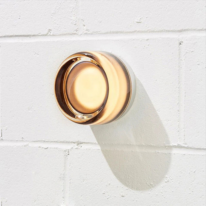 Amber Dimmable Round LED Wall Sconce on brick wall