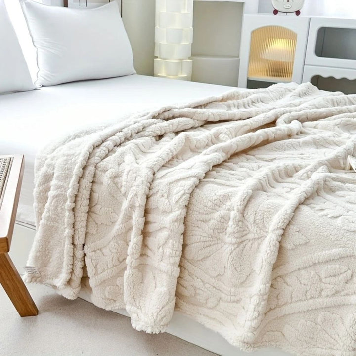 Ivory Cloud Embossed Plush Fleece Throw in a bedroom