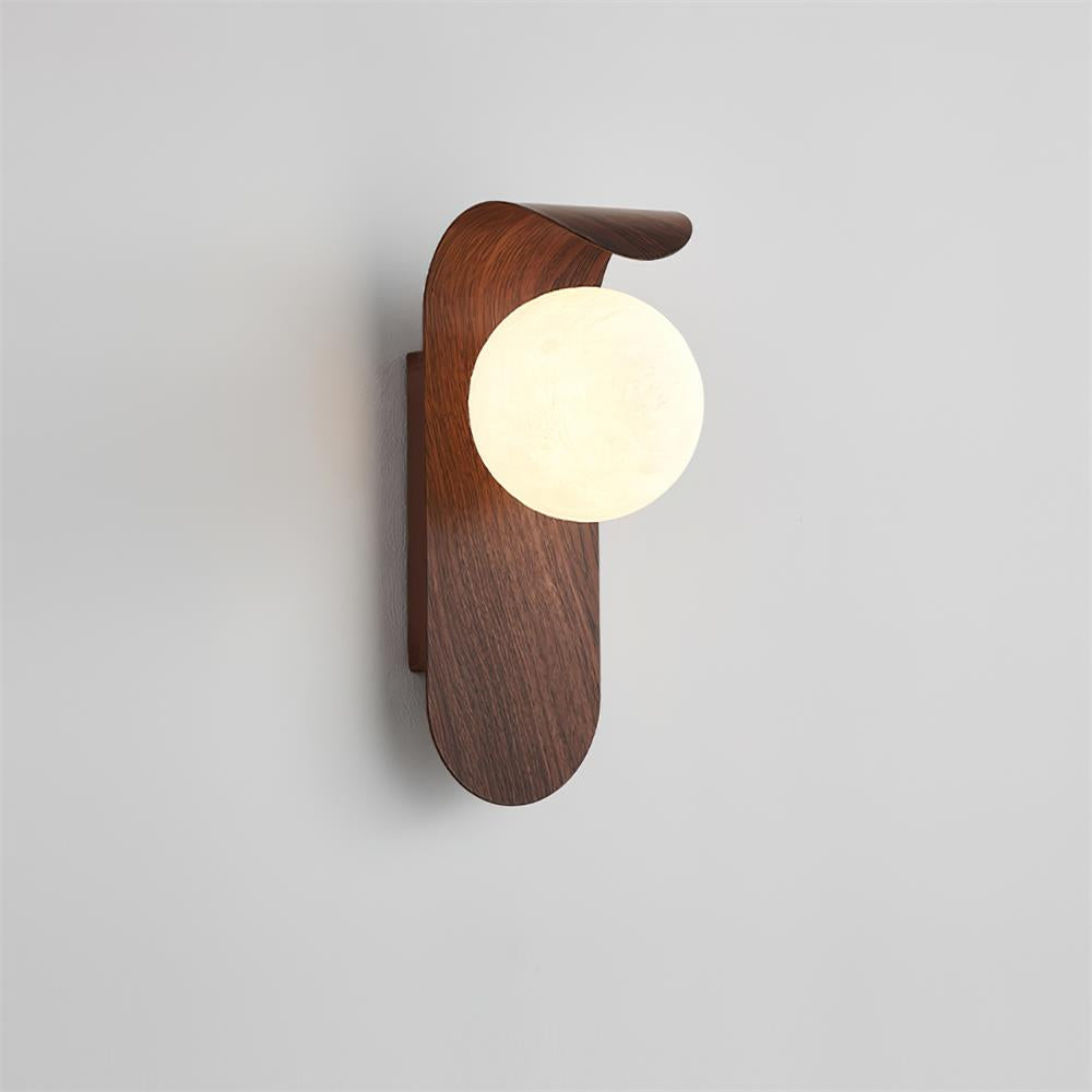 Walnut Faux-Wood Curved Arm Sconce lit on wall