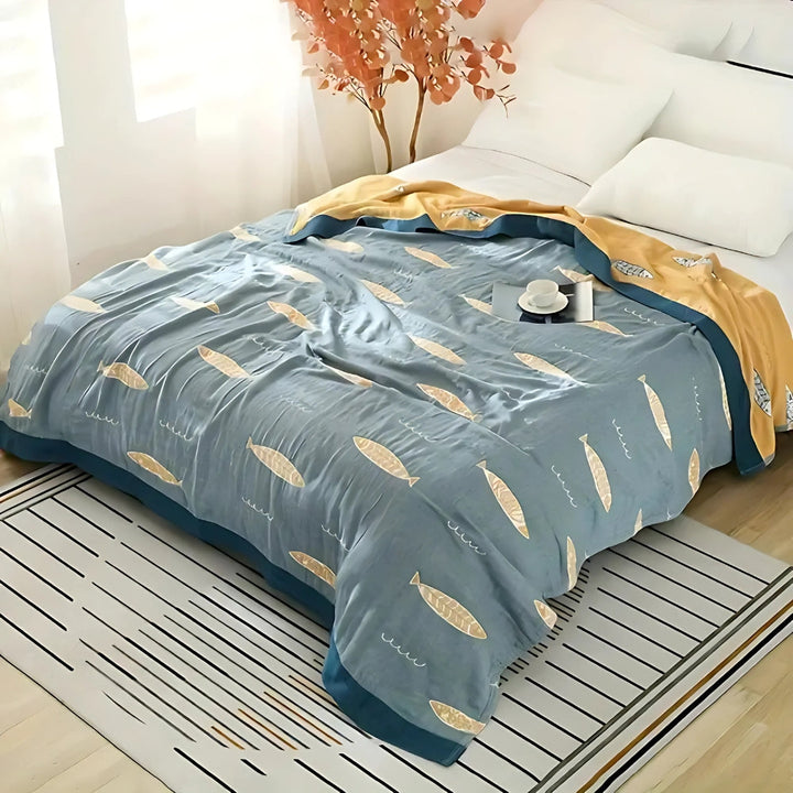 Ocean Blue Fish Jacquard Cotton Gauze Blanket spread on bed