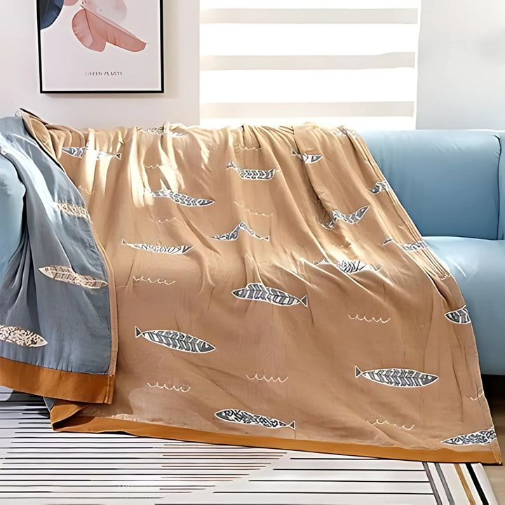 Fish Jacquard Cotton Gauze Blanket reverse side draped over sofa