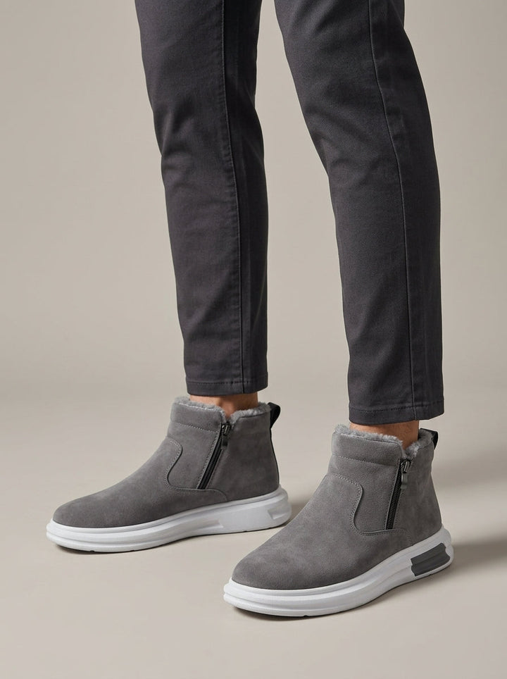 Grey fur-lined ankle boots worn on model