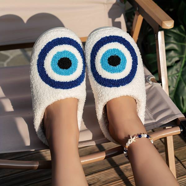 White Fuzzy Evil Eye Slide Slippers worn outdoors