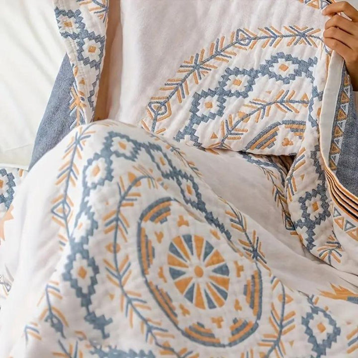Ivory geometric medallion cotton throw blanket, folded detail