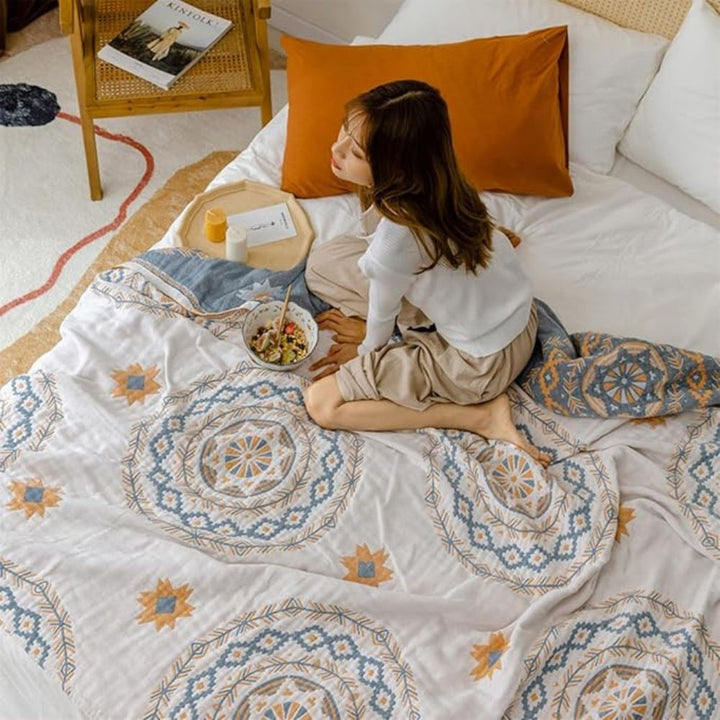 Ivory geometric medallion cotton throw blanket on sofa