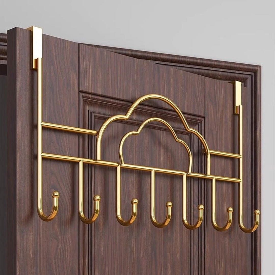 Gold cloud over-door coat hook rack mounted on a door