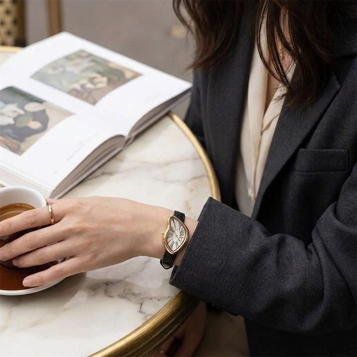 Gold-Tone Roman Numeral Dress Watch with white dial worn at cafe table