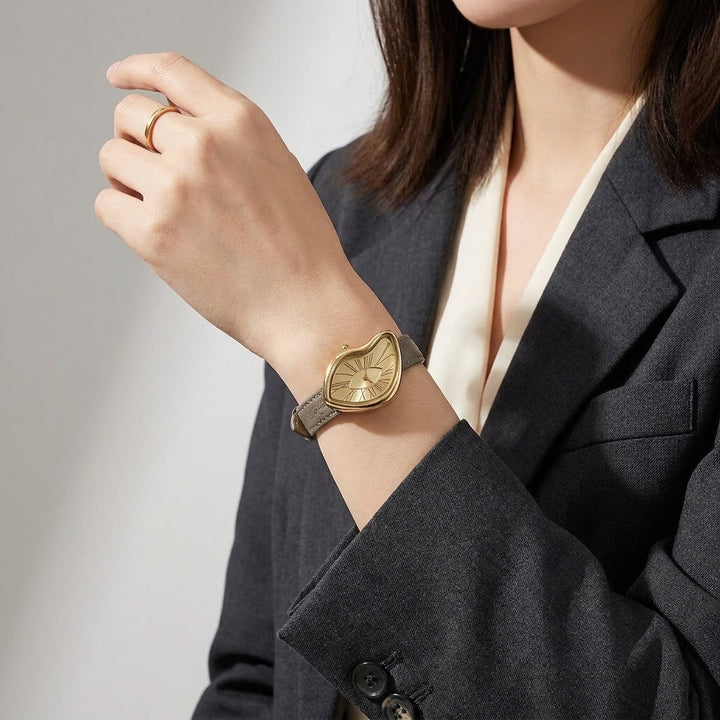 Gold-Tone Roman Numeral Dress Watch with taupe strap worn on wrist