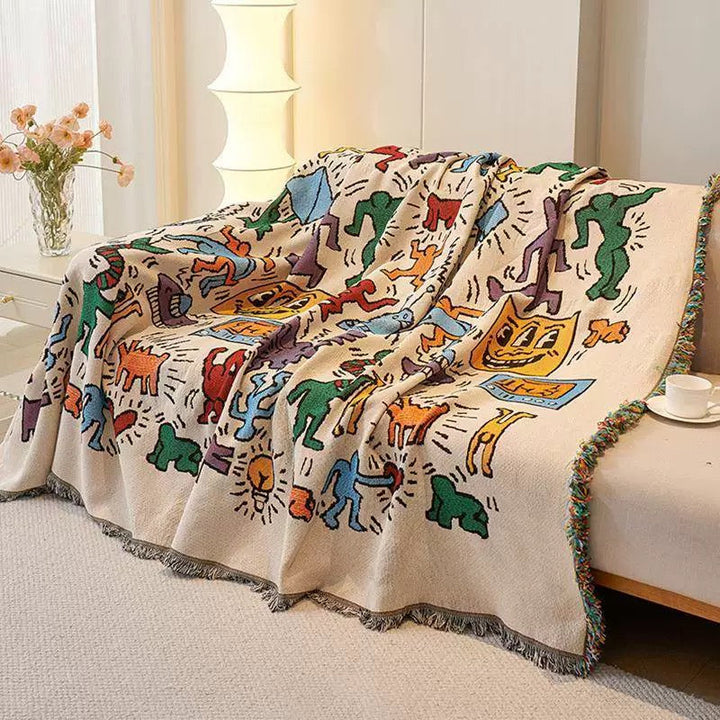 Multicolor Graffiti Pop Art Woven Throw Blanket draped over sofa