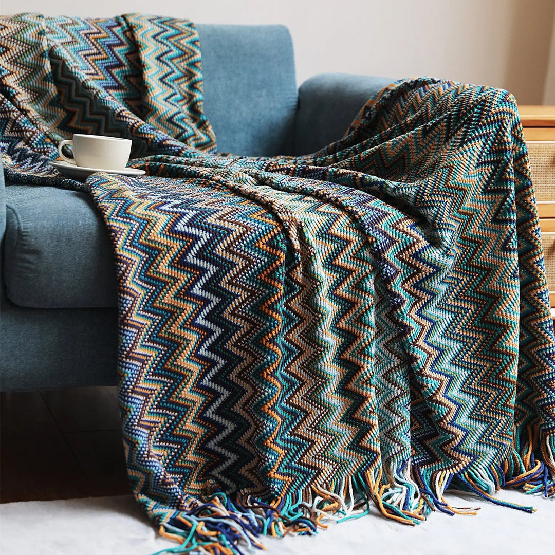 Blue Hand-Knit Chevron Throw Blanket draped on sofa