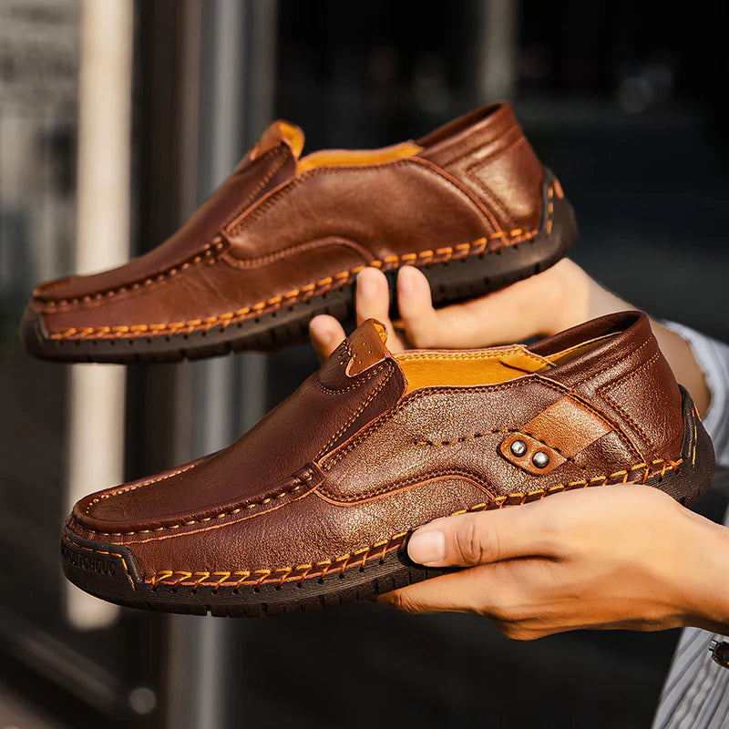 Brown Leather Loafers held in hand