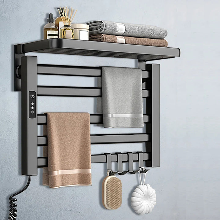 Gray heated towel rack wall mounted with towels and shelf