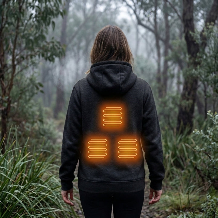 Black heated zip-up hoodie worn outdoors with heating zones highlighted