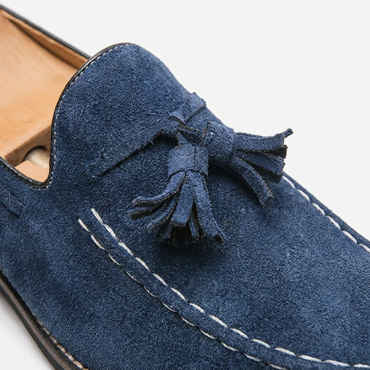 Suede tassel loafers pair angled view