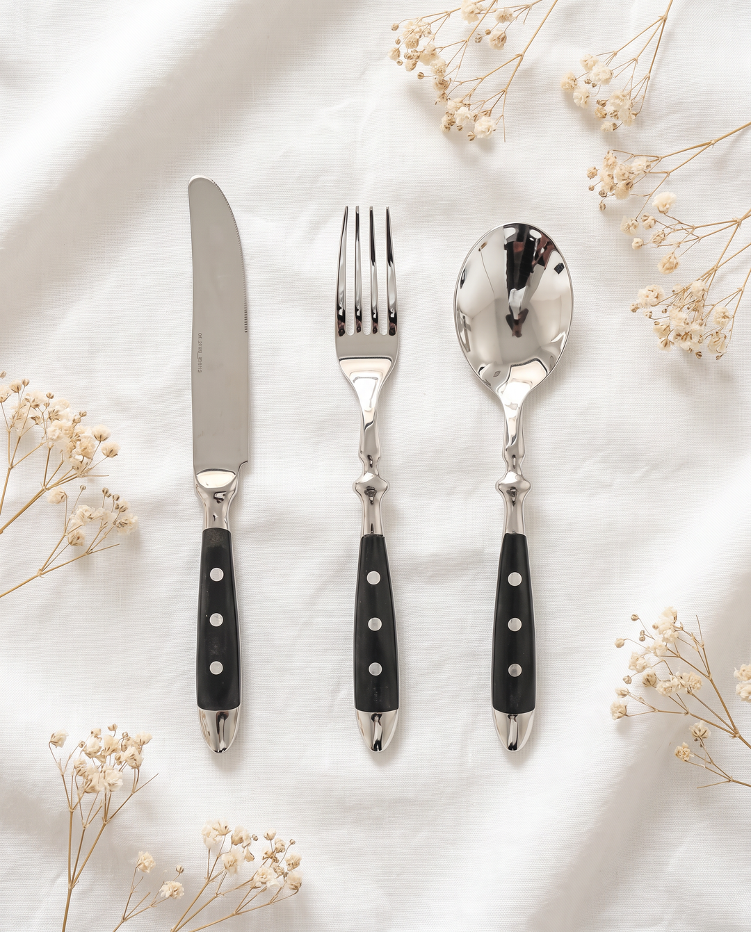 Elegant Black Stainless Steel Cutlery 3-piece set flat lay on linen