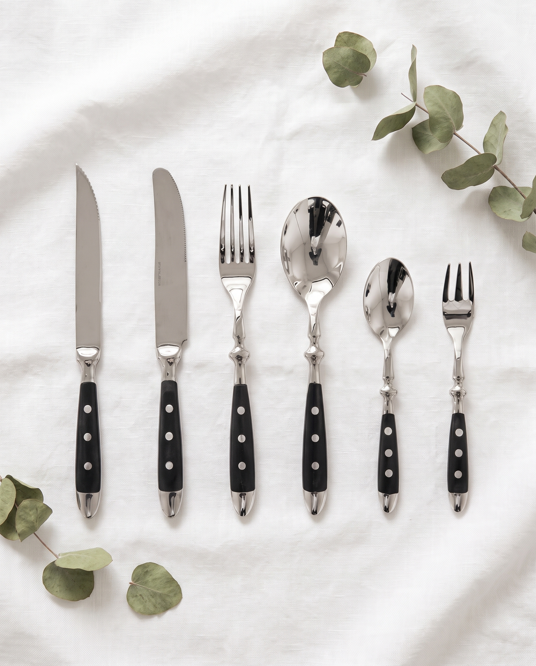 Elegant Black Stainless Steel Cutlery 6-piece set flat lay on linen