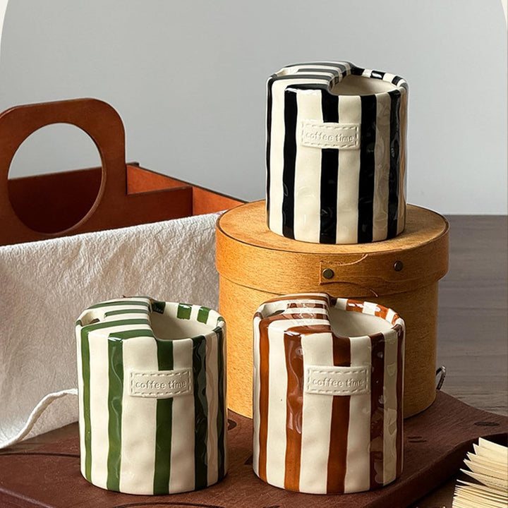 Black, Green, and Brown Retro Striped Ceramic Mugs styled with wooden crate