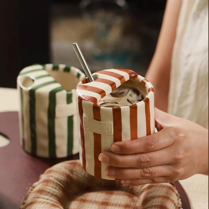 Brown Retro Striped Ceramic Mug held in hand with iced coffee