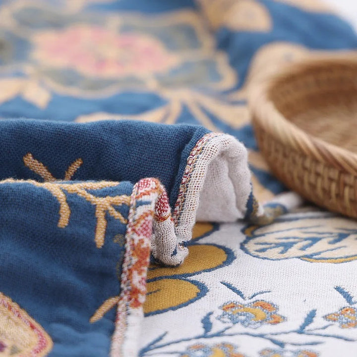 Jacquard Wildflower Cotton Throw styled with a basket beside a bed