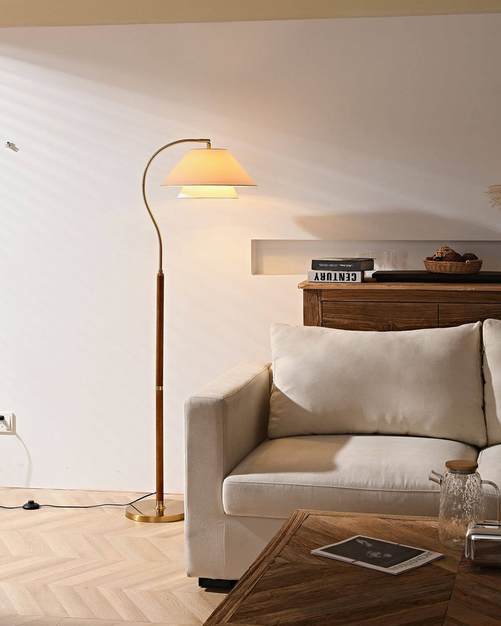 Walnut Layered Fabric Shade Arc Lamp illuminated over sofa