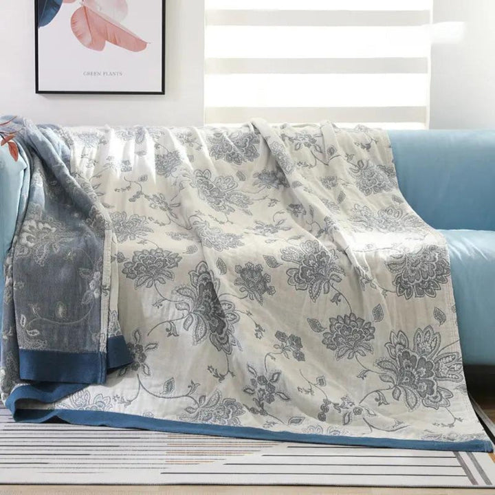 Blue Layered Gauze Floral Cotton Throw on a sofa