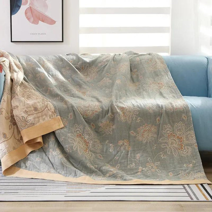 Green Layered Gauze Floral Cotton Throw on a sofa