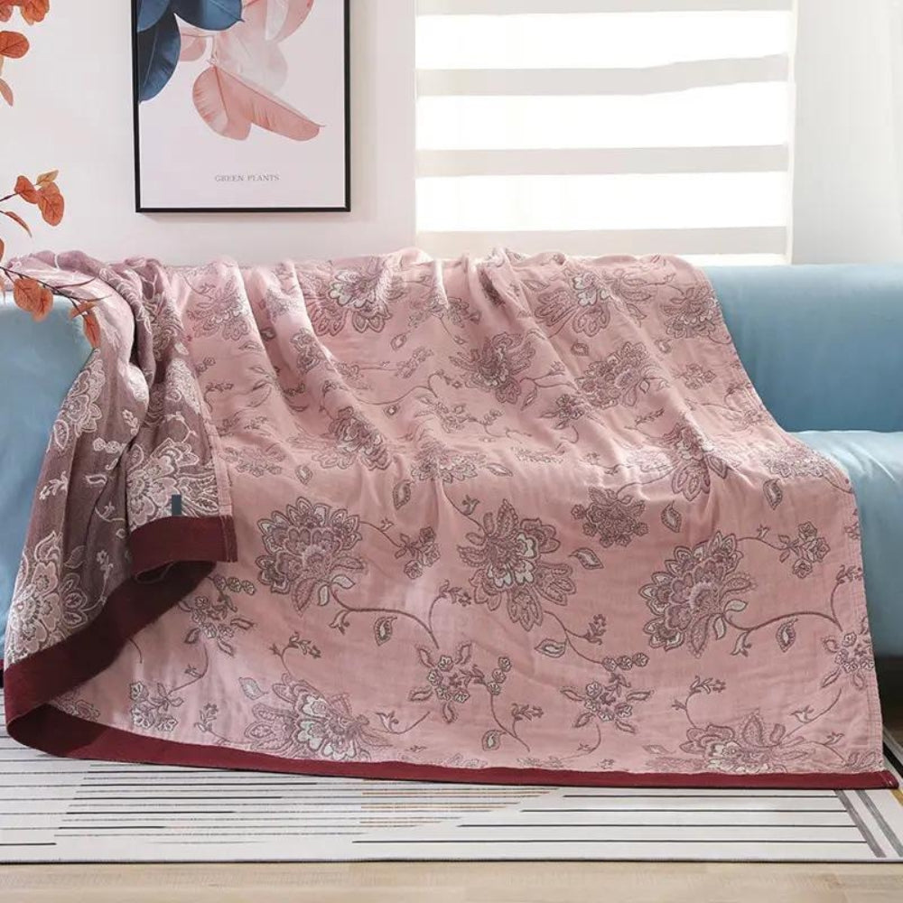 Pink Layered Gauze Floral Cotton Throw on a sofa