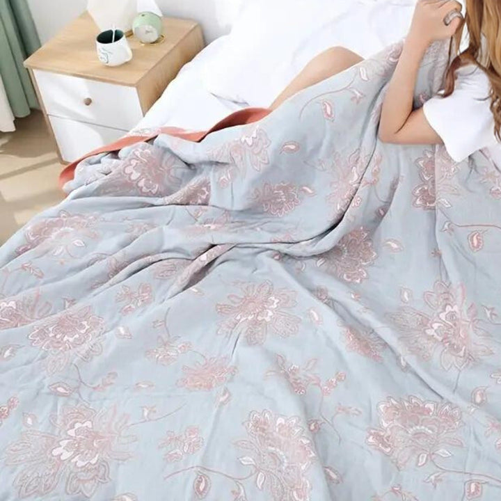 Blue Layered Gauze Floral Cotton Throw lifestyle on a bed