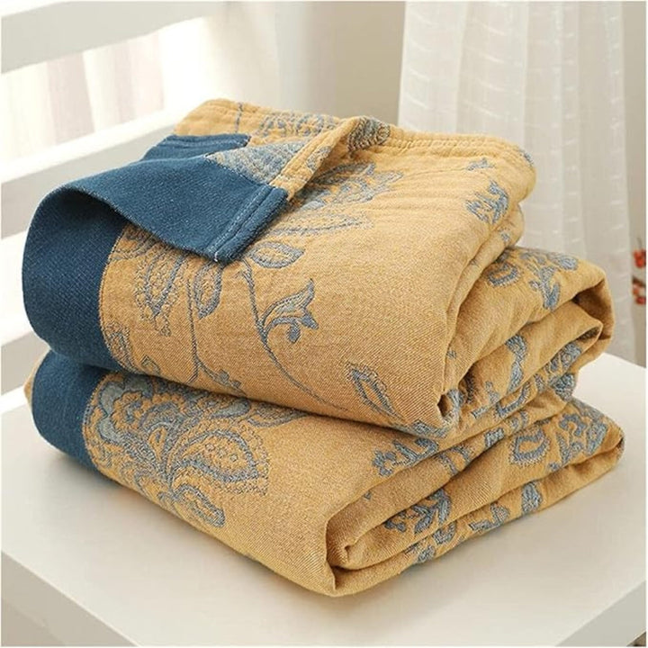 Layered Gauze Floral Cotton Throw folded stack in blue and yellow