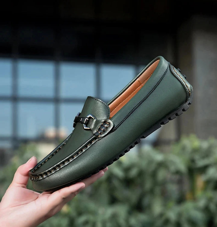 Green Leather Driving Loafers held in hand