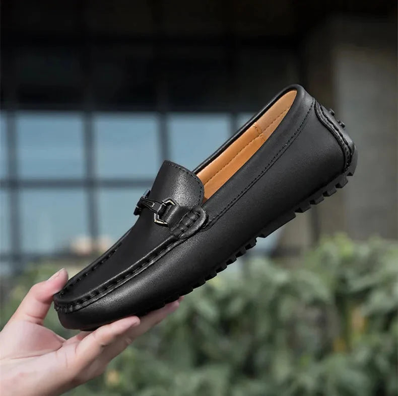 Black Leather Driving Loafers held in hand
