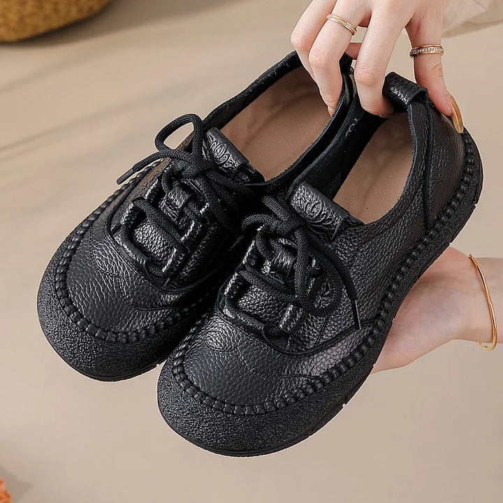 Black Leather Platform Sneakers held in hand