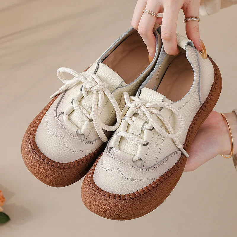 White Leather Platform Sneakers held in hand