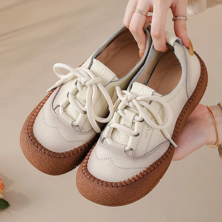 White Leather Platform Sneakers held in hand