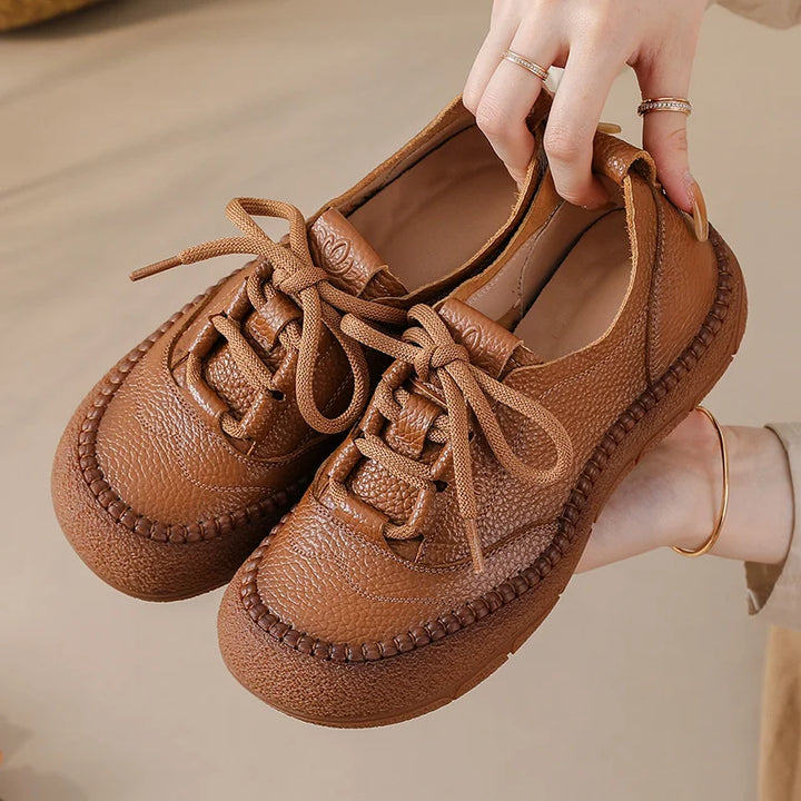 Brown Leather Platform Sneakers held close-up