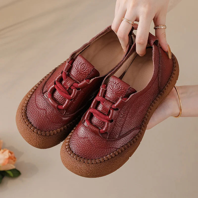 Burgundy Leather Platform Sneakers held in hand